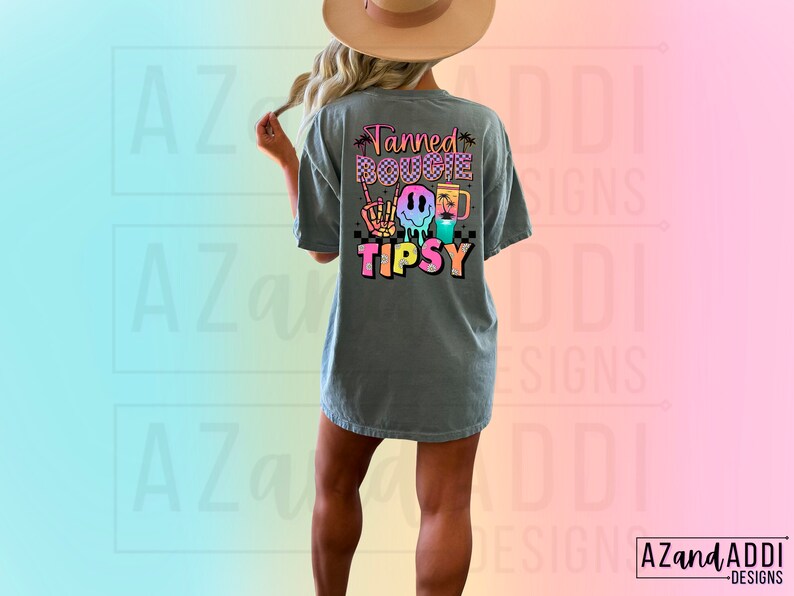 May include: A grey t-shirt with a colourful graphic that says "Tanned Bougie Tipsy" with a smiley face, palm trees, and a drink.