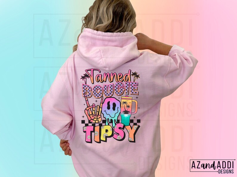 May include: Pink hoodie with a graphic print that says "Tanned Bougie Tipsy" with a smiley face, palm trees, and a drink.