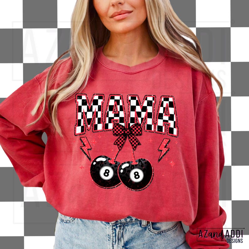 May include: Red sweatshirt with the text "MAMA" in black and white checkered letters. The letters are outlined in white and have a glittery effect. Two black and white 8-ball cherries are hanging from a red bow.