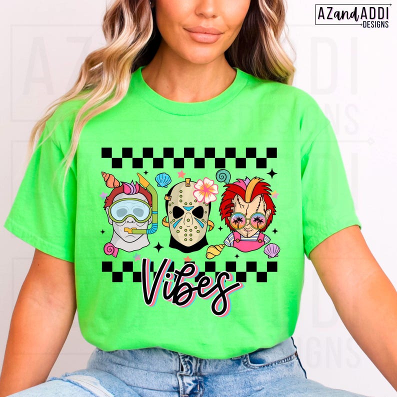 May include: A neon green t-shirt featuring a graphic with three cartoon characters: a scuba diver, Jason Voorhees, and Chucky. The word "Vibes" is written in a cursive font below the characters. The design includes black and white checkered patterns and seashell accents.