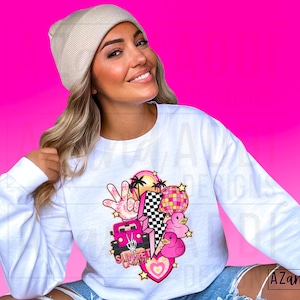 May include: White long-sleeve sweatshirt with a pink and white graphic design featuring a car, palm trees, a peace sign, a disco ball, and the text "Sunset Groovy".