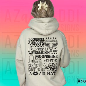 May include: A white hoodie with a black graphic print on the back. The graphic includes the text "Cowgirl Fringe Boots", "Howdy Y'all", "Watermelon", "Moonshine", "Bell Bottoms", and "Cute Hat".