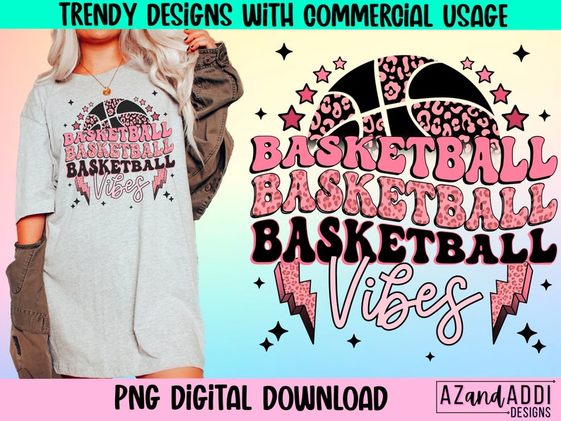 May include: A light gray t-shirt with a basketball graphic and the words "BASKETBALL VIBES" in pink and black. The design includes a basketball with a leopard print pattern, stars, and lightning bolts. The text "PNG DIGITAL DOWNLOAD" is also visible.