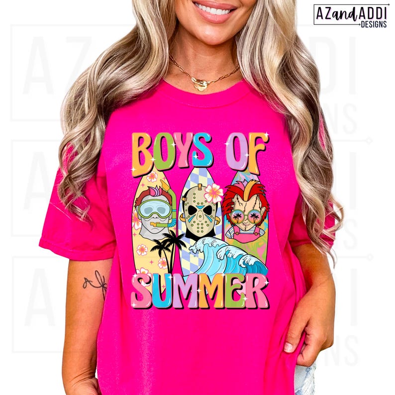 May include: A hot pink t-shirt with the words "BOYS OF SUMMER" in colorful, retro lettering. The graphic features three cartoon characters on surfboards, with a wave and palm trees. The shirt is a vibrant, eye-catching design.