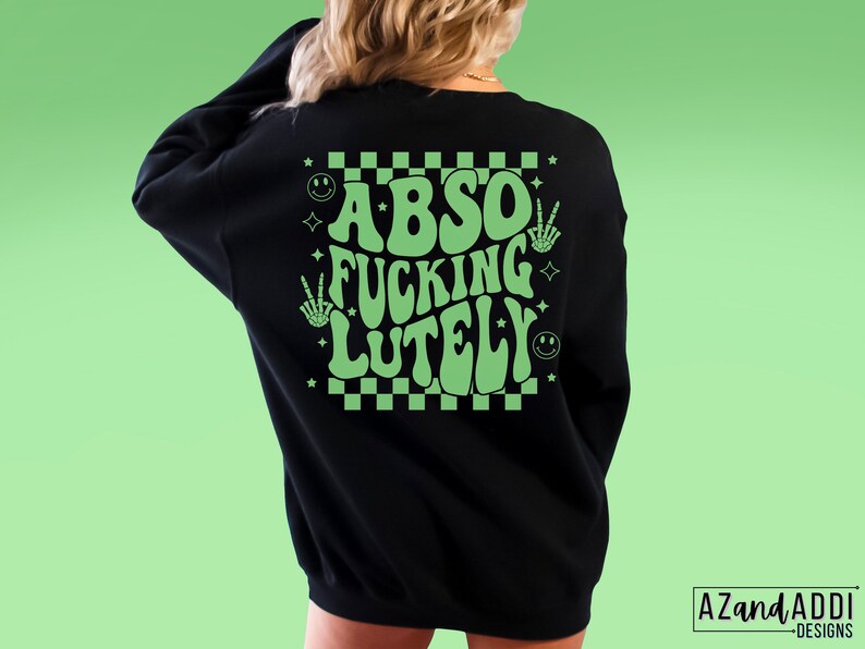 May include: Black sweatshirt with a green checkered pattern and the text "ABSO FUCKING LUTELY" in a retro font.