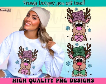 May include: White sweatshirt featuring a cartoon reindeer design with a pink and green patterned hat and bow tie. The reindeer has a leopard print pattern and is surrounded by snowflakes. The text "Trendy Designs you will love!!" and "HIGH QUALITY PNG DESIGNS" are also visible.