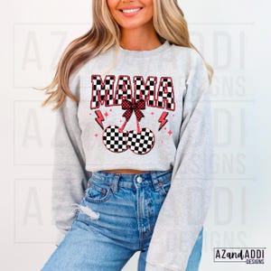 May include: A gray sweatshirt with a checkered pattern design that says "MAMA" in black and white with a red bow and cherries. The cherries are also checkered.
