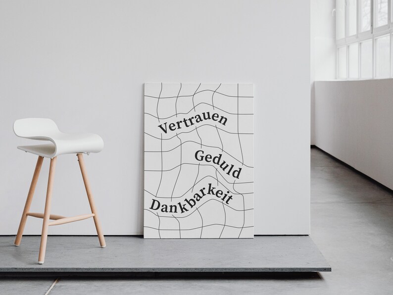 May include: A white poster with black grid lines and the words "Vertrauen", "Geduld", and "Dankbarkeit" written in a wavy font.