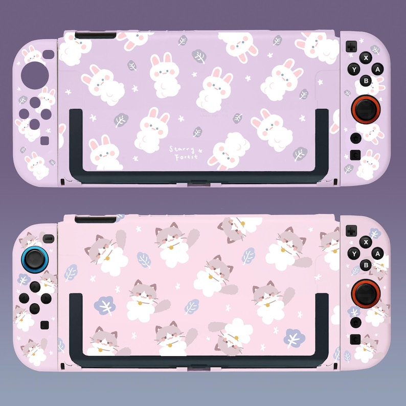May include: Two pink Nintendo Switch console cases with different designs. The top case features a purple background with white bunnies and the text "Starry Forest". The bottom case features a pink background with white cats.