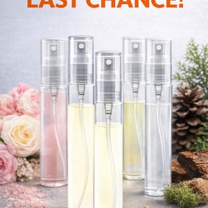 May include: The Bookaholics Perfumes. Clear glass spray bottles filled with various colored liquids. The text "LAST CHANCE!" is in orange. Pink and white roses are in the background. The text "2 FOR $8.00" is at the bottom.