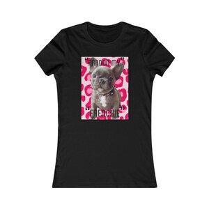 May include: Black women's t-shirt with a graphic of a French bulldog puppy on a pink leopard print background. The text "Pardon my Frenchie" is written in black on the graphic.