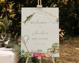 Op de afbeelding: Welkom op Amelia's babyshower bord met een vissersthema. Het bord heeft een aquarel illustratie van een hengel, een vis, een visnet, een lantaarn, een viskist, een hoed en een stoel. De tekst op het bord luidt "Welkom op Amelia's babyshower 15 augustus 2024".