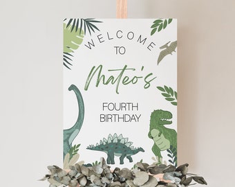 May include: Welcome to Mateo's Fourth Birthday sign with a green dinosaur, a green pterodactyl, and green leafy plants on a white background.