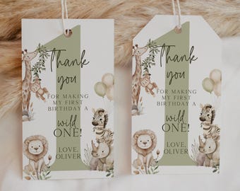 May include: Two gift tags with a safari theme. Each tag features a giraffe, lion, zebra, and rhino illustration. Text reads "Thank you for making my first birthday a wild one! Love, Oliver."