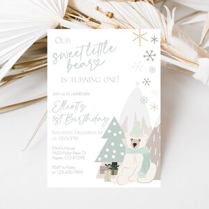 May include: A birthday invitation with a winter theme. The text reads "Our sweet little beary is turning one!" and "Elliotts 1st Birthday". The design includes a polar bear wearing a hat and scarf, a Christmas tree, snowflakes, and mountains.