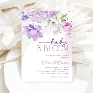 May include: A purple and white floral bridal shower invitation with the text "baby in bloom" and the name "Olivia Peterson". The invitation includes the date, time, location, and RSVP information. It also states that the guest of honor is registered at Amazon.