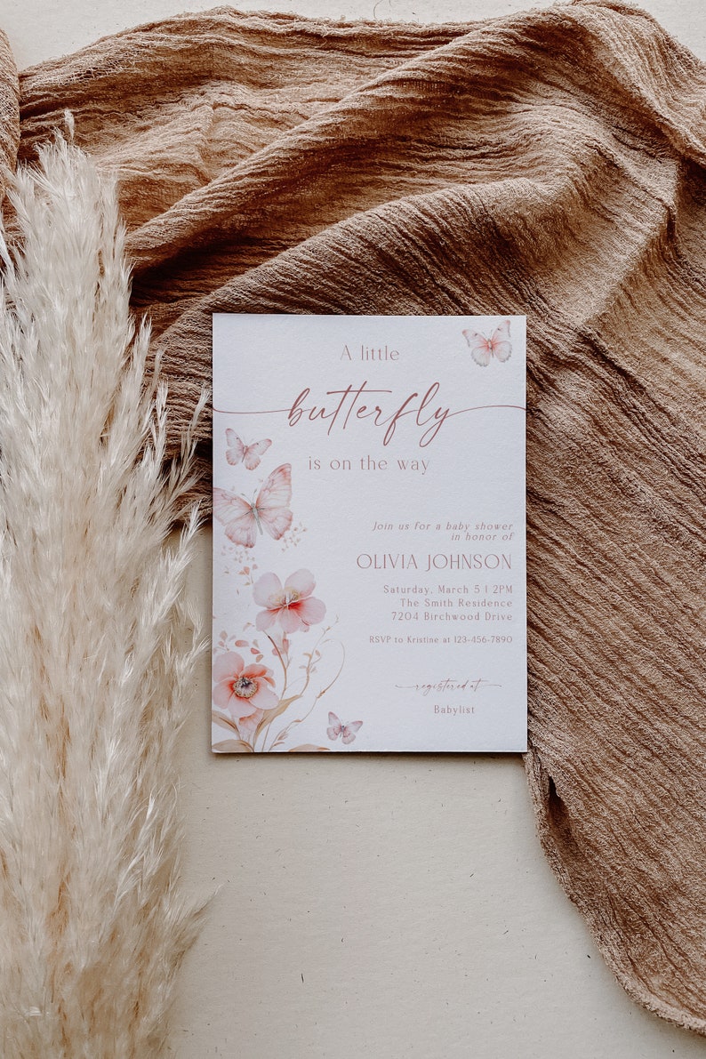 May include: A white baby shower invitation with pink butterflies and flowers. The text reads "A little butterfly is on the way."  Join us for a baby shower in honor of Olivia Johnson. Saturday, March 5 1:2PM. The Smith Residence. 7204 Birchwood Drive. RSVP to Kristine at 123-456-7890. Registered at Babylist.