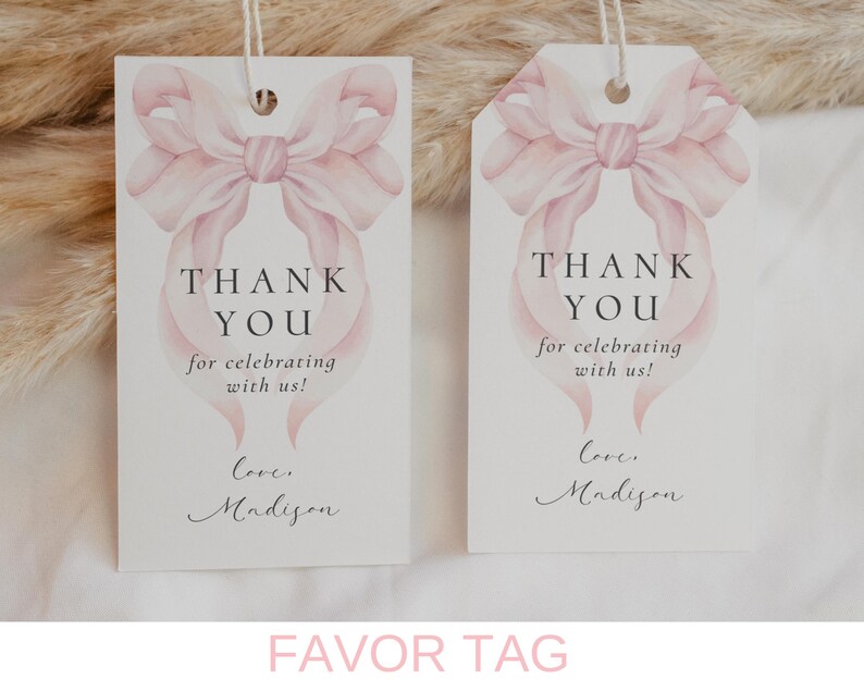 May include: Two white favor tags with a pink watercolor bow design. The text on the tags reads "Thank You for celebrating with us! Love, Madison".
