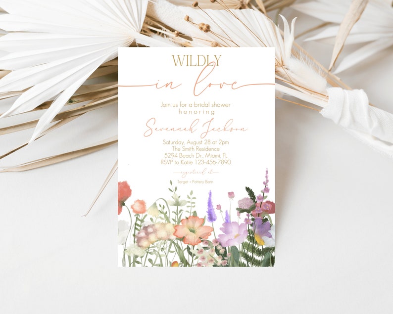 May include: A white bridal shower invitation with a floral border. The invitation reads "WILDLY in love" and includes the bride's name, date, time, location, and RSVP information.