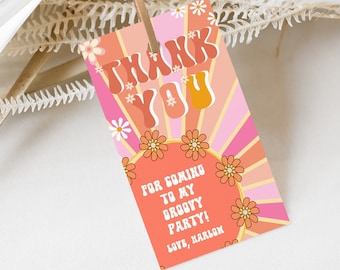 May include: A pink and orange thank you tag with a groovy 70s style font. The tag says "Thank You" with a sunburst design and flowers. The text below says "For coming to my groovy party! Love, Harlow"