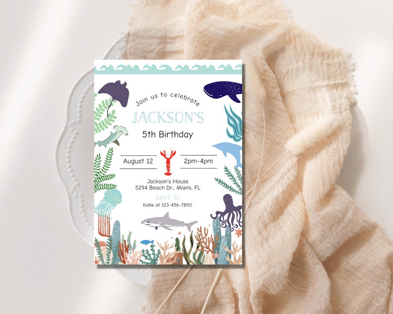 May include: A blue and white invitation card with a sea life theme. The card says "Join us to celebrate JACKSON'S 5th Birthday" and includes details about the party, including the date, time, location, and RSVP information.
