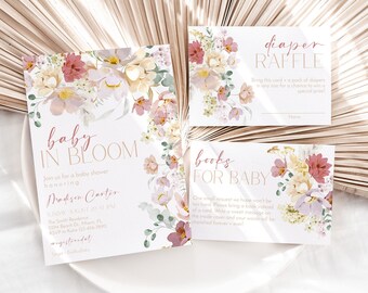 May include: A set of three floral baby shower cards with pink, yellow, and green flowers. The cards are for a diaper raffle, books for baby, and a baby shower invitation. The invitation reads "Baby in Bloom" and is for Madison Carter.