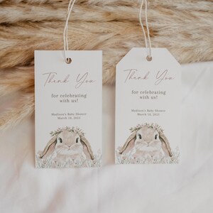 May include: Two white thank you tags with a bunny rabbit illustration and pink floral accents. The text on the tags reads "Thank You for celebrating with us!" and "Madison's Baby Shower March 18, 2022".