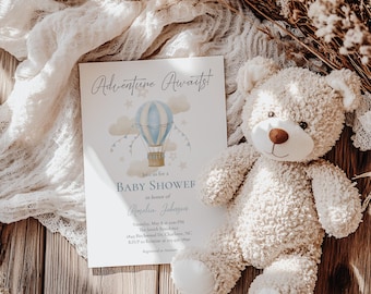 May include: A baby shower invitation with a blue and white hot air balloon illustration. The invitation reads "Adventure Awaits" and includes the text "Join us for a Baby Shower in honor of Amelia Johnson".