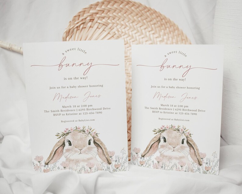 May include: A baby shower invitation with a pink and white floral design featuring a cute bunny rabbit with a flower crown. The text reads "A sweet little bunny is on the way!" and includes the name "Madison Jones" and details for the shower.