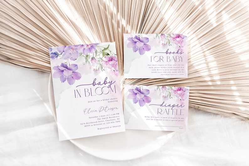 May include: Purple floral baby shower invitation with the text "baby in bloom" and details for a bridal shower for Elsie Peterson.  There are two additional cards with the text "books for baby" and "diaper raffle".