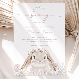 May include: A baby shower invitation with a watercolor illustration of a bunny wearing a flower crown. The invitation reads "a sweet little bunny is on the way!" and includes the name "Madison Jones", the date and time of the shower, the address, and RSVP information.