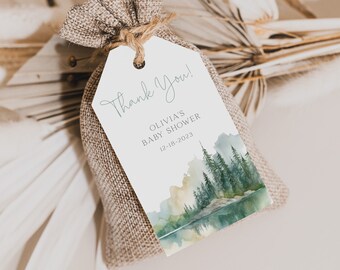May include: A white thank you tag with a watercolor illustration of a forest scene. The tag says "Thank You! Olivia's Baby Shower 12-18-2023".