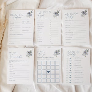 May include: A set of baby shower game cards with a blue and white floral design. The cards include games like "Predictions Advice", "The Price is Right", "Wishes for Baby", "Word Scramble", "Baby Bingo", and "Mommy or Daddy".