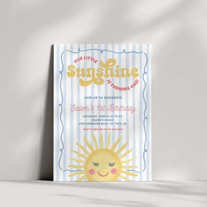 May include: A birthday invitation with a blue and white striped background. The text "OUR LITTLE Sunshine IS TURNING ONE!" is in yellow and red. The invitation also includes the text "Salem's 1st Birthday" and a smiling sun illustration.