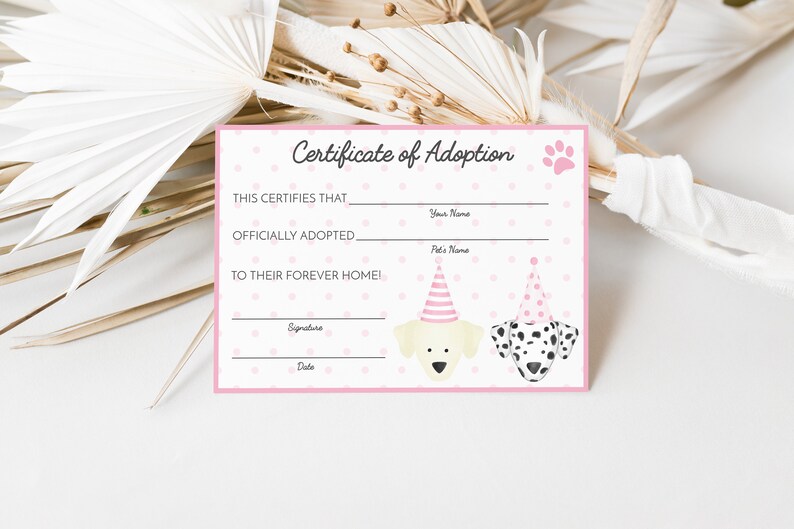 May include: A pink and white certificate of adoption with a paw print and two dogs wearing party hats. The text reads "This certifies that ______ officially adopted ______ to their forever home!"