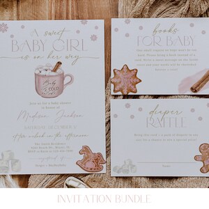 May include: A set of printable baby shower invitations with a winter theme. The invitations feature a pink and white color scheme with illustrations of a mug of hot chocolate, a gingerbread man, a rocking horse, and snowflakes. The text on the invitations reads "A sweet baby girl is on her way", "books for baby", and "diaper raffle".