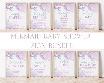 May include: A set of eight printable signs for a mermaid themed baby shower. The signs feature a mermaid tail with purple and blue scales and a variety of text, including "Diaper Raffle", "Late Night Diapers", "Mimosas Bar", "Don't Say Baby", "Please Sign the Guestbook", "Babies are Sweet", "Pacifier Hunt", and "Measure the Baby Bump".