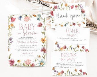 May include: Baby shower invitation with floral border and text that reads "Baby in Bloom". The invitation includes the name Amelia Johnson, the date and time of the shower, and the location. The invitation also includes information about the registry and a thank you card with floral border.