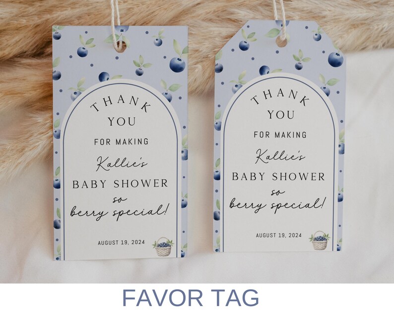 May include: Two blue and white favor tags with a blueberry design. The text on the tags reads "Thank You for making Kallie's Baby Shower so berry special!" with the date August 19, 2024.