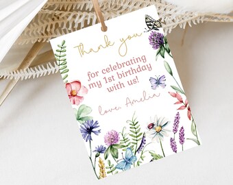 May include: A white thank you card with a floral design and butterflies. The text reads "Thank you for celebrating my 1st birthday with us! Love, Amelia."
