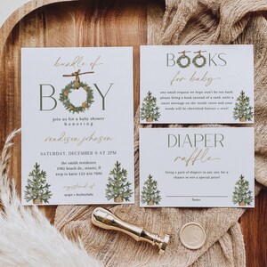 May include: Baby shower invitation suite with a rustic theme. The invitation features the word "BOY" with a wreath, and the text "bundle of" above it. Includes cards for books and a diaper raffle, plus a gold wax seal.