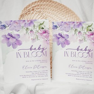 May include: Purple floral baby shower invitation with the text "baby in bloom" and the name "Olivia Peterson". The invitation includes the date, time, location, and RSVP information. It also states that the guest of honor is registered at Amazon.
