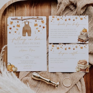 May include: Baby shower invitation set with a fall theme. The invitation features watercolor overalls and autumn leaves. Includes a book request card, diaper raffle card, and a gold wax seal.