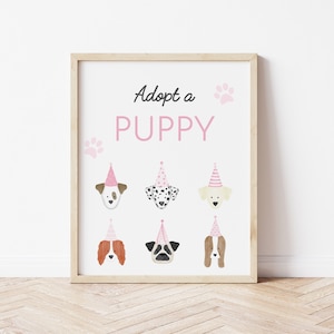 May include: Adopt a Puppy sign with six different puppy faces wearing pink party hats. The sign has a white background with pink paw prints and the text "Adopt a Puppy" in black.