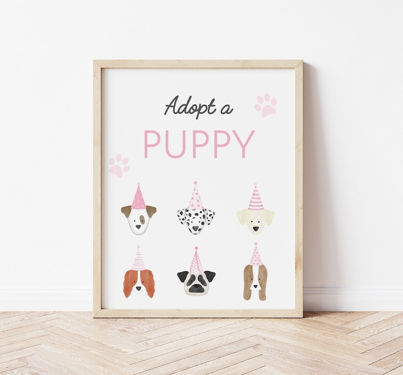 May include: Adopt a Puppy sign with six different puppy faces wearing pink party hats. The sign has a white background with pink paw prints and the text "Adopt a Puppy" in black.