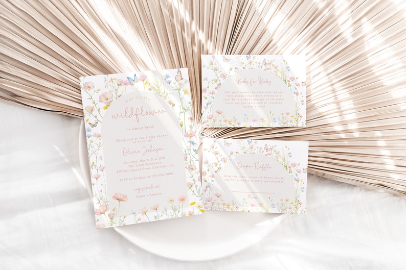 May include: Three cards with a floral design featuring butterflies and the text "Our little wildflower is almost here."  The cards are for a baby shower and include information about the event, a diaper raffle, and a "Gifts for Baby" section.