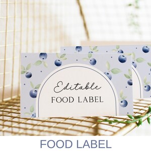 May include: Editable food label with a watercolor design of blueberries and leaves on a light blue background. The text "Editable Food Label" is printed in black.