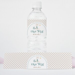 May include: Water bottle label with a checkered pattern and a palm tree graphic. The label says "1 the big one".