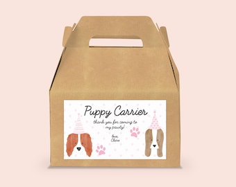 May include: A brown cardboard box with a handle, labeled "Puppy Carrier" with a pink and white polka dot background. The label features two cartoon dogs wearing pink party hats. The text on the label reads "Thank you for coming to my pawty! Love, Claire."