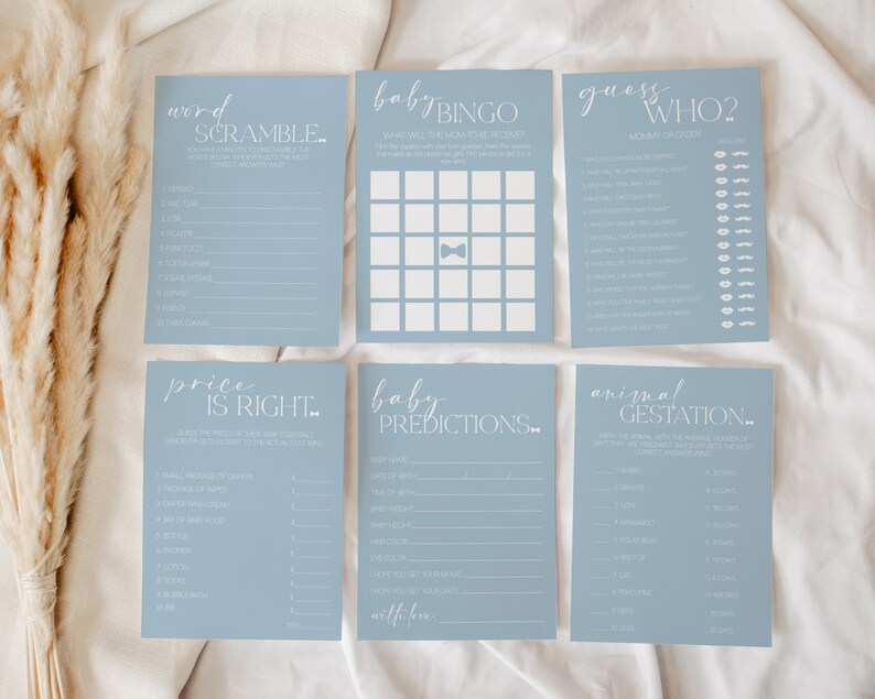 May include: A set of ten blue baby shower game cards with white text. The games include: Word Scramble, Baby Bingo, Guess Who, Price is Right, Baby Predictions, and Animal Gestation.